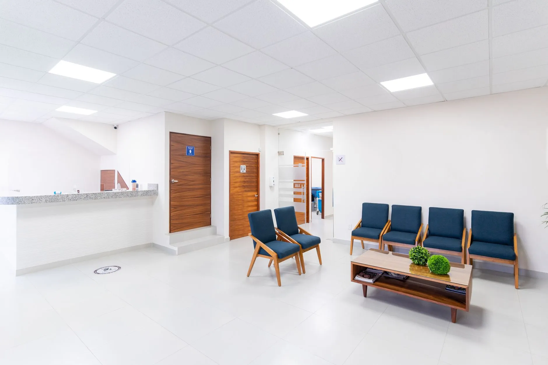 Quầy tiếp đón của một phòng khám sáng đèn vào buổi tối với nhân viên đang tiếp khách.